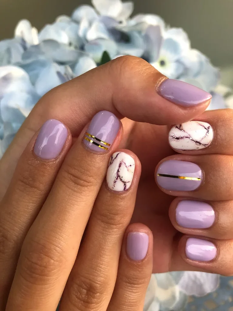 lavender gel nails with marble design and gold lines manicure at honu nails
