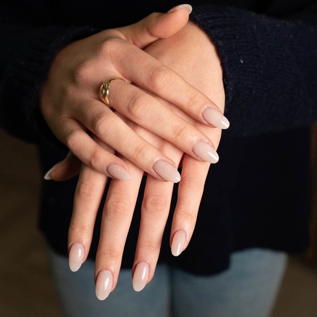 Clean nude gel manicure at H’ONU with glossy finish and almond shape for a natural elegant look