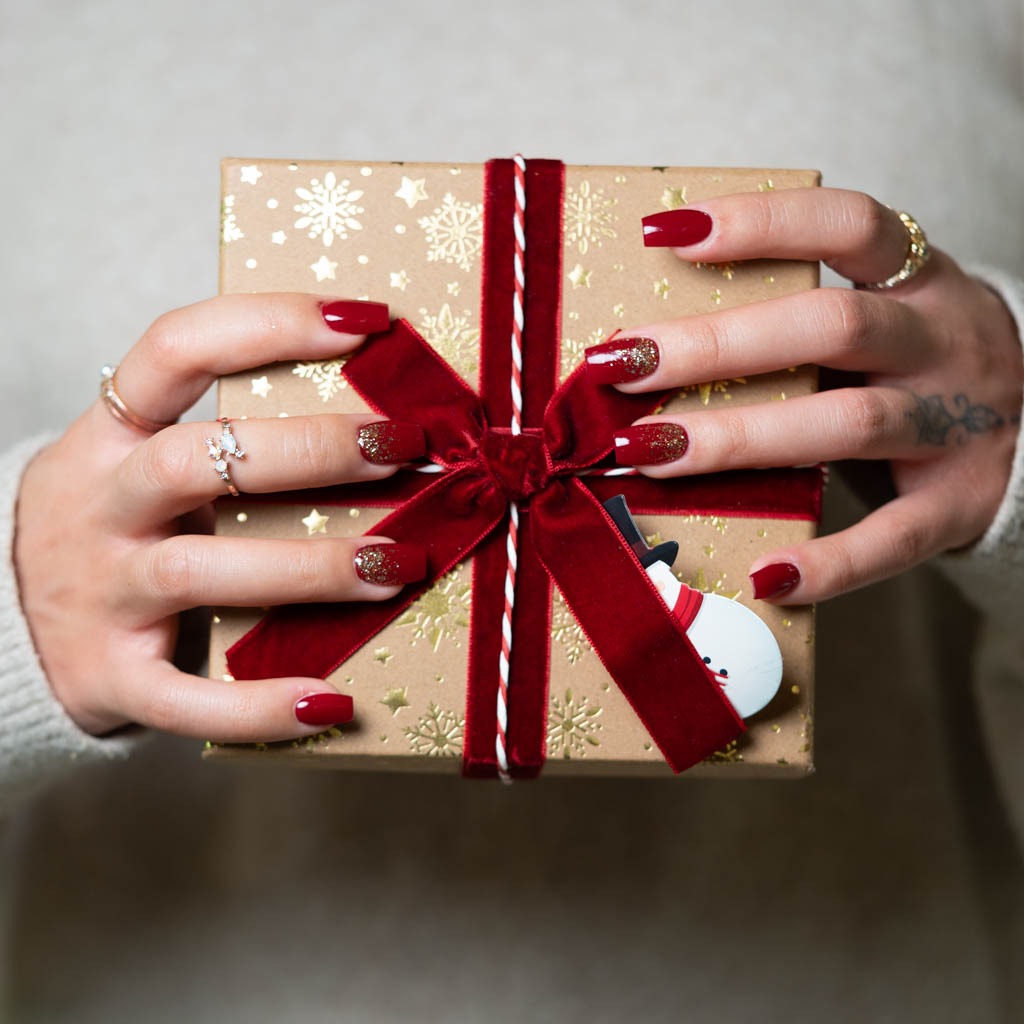 Red glitter holiday nails at H’ONU with glossy finish and festive manicure design